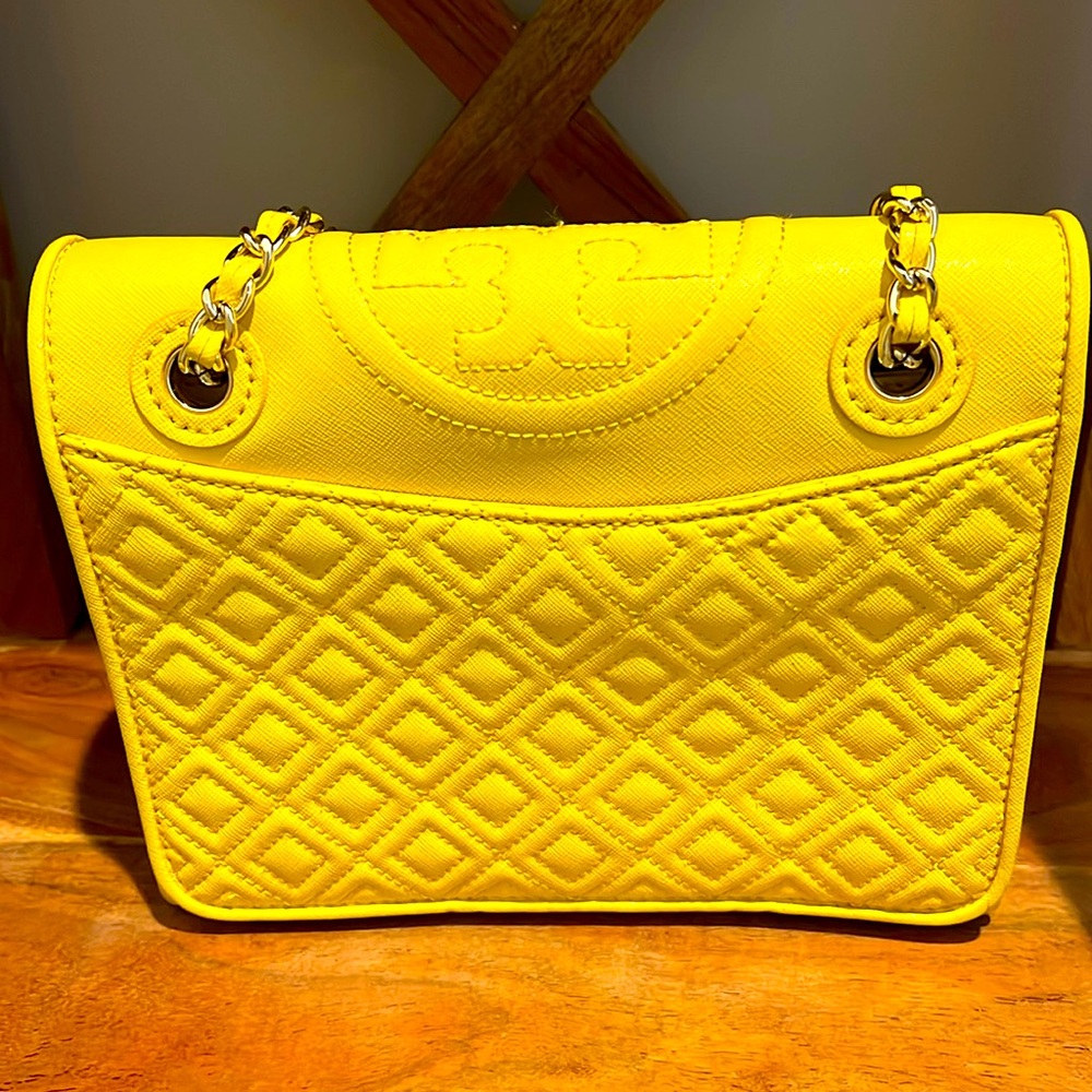 Yellow Tory Burch crossover handbag.